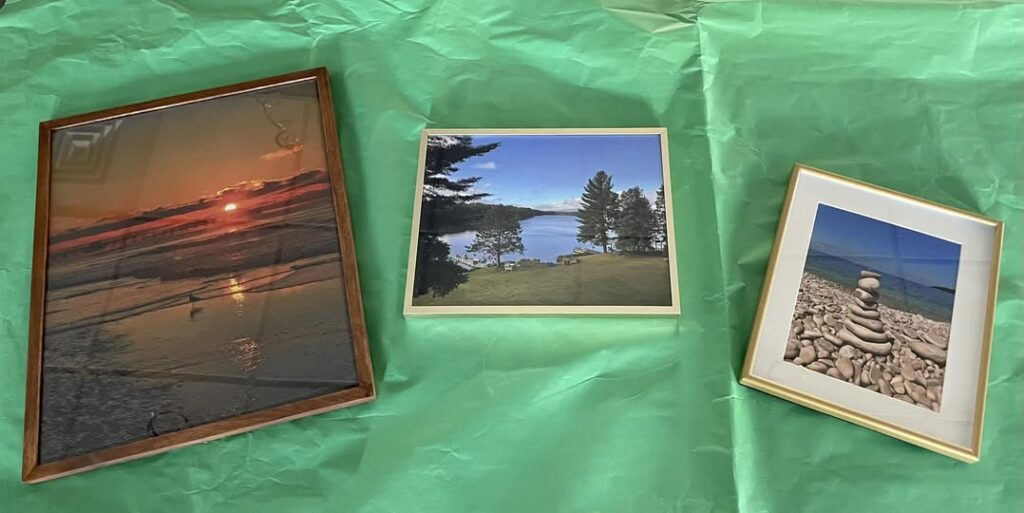 3 pictures framed that were winners of the photo contest