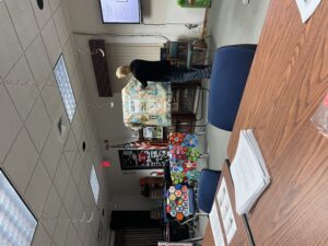 Shari points out pictures of Seymour libraries in her quilt.