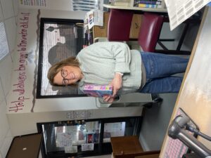 Leslie holding up a book that she selected for our library!