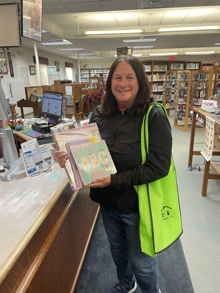 Virginia is holding up spring books that we gathered for her and she has just checked out.